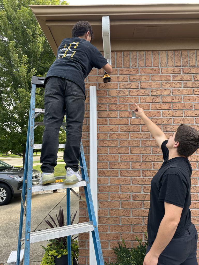 Downspout repair in Macomb Michigan with 2 of our technicians. 