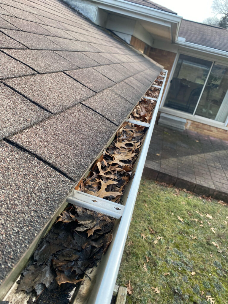 Gutter with leaves from gutter cleaning in Rochester Michigan 