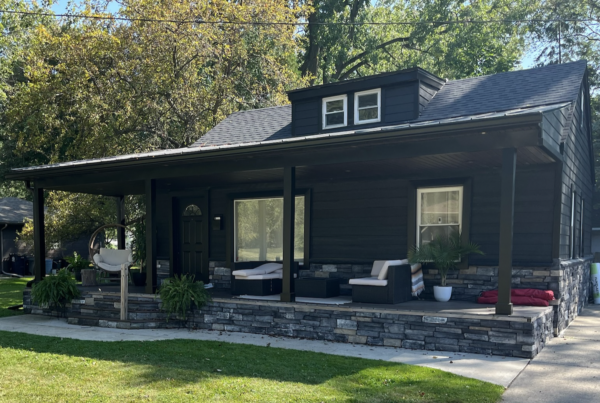 home with black siding with black gutters