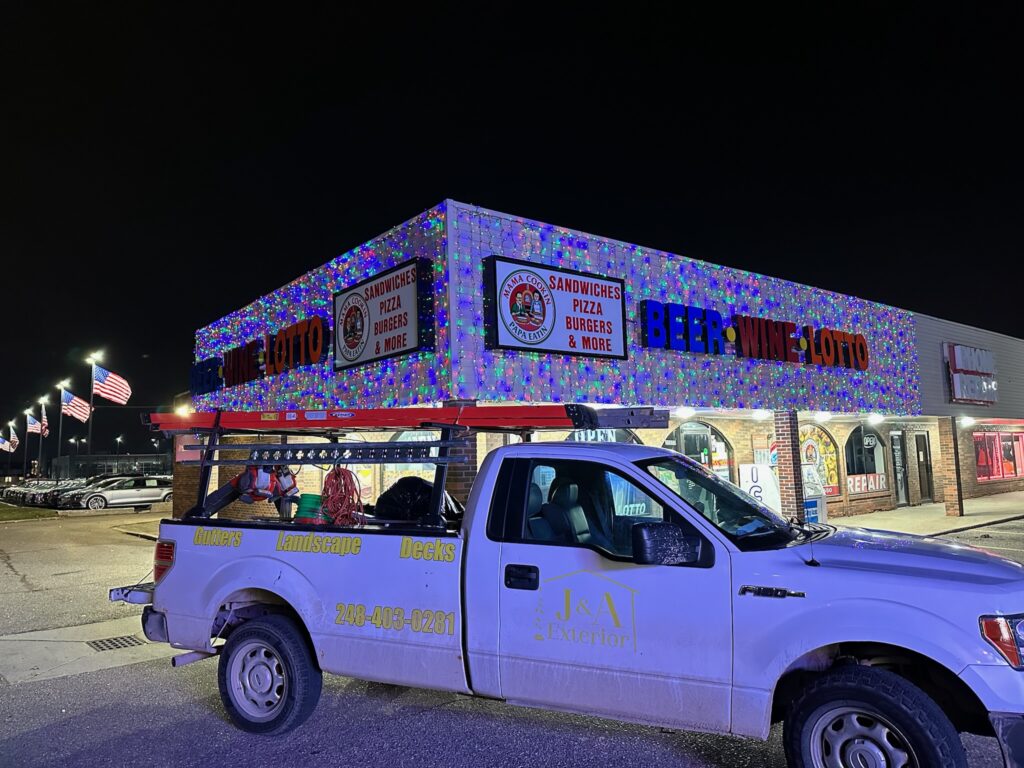 liquor store with multi color lights and J&A Exterior white work truck