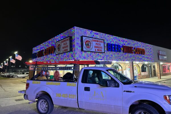liquor store with multi color lights and J&A Exterior white work truck