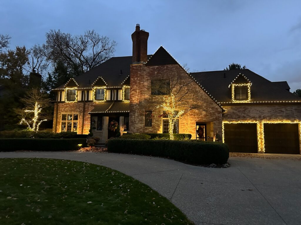 Brown brick house with white holiday lights