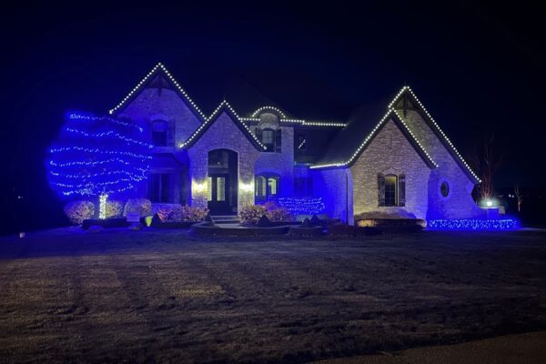 Grey brick home with white and blue lights