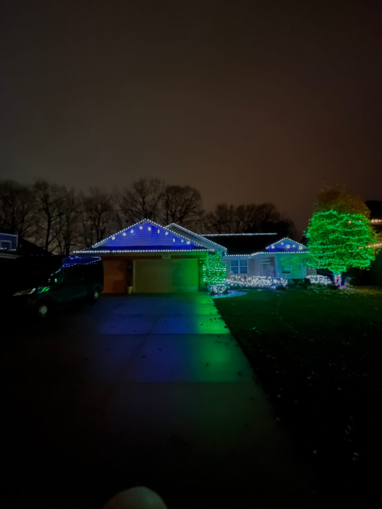 House with white, blue and green holiday lights