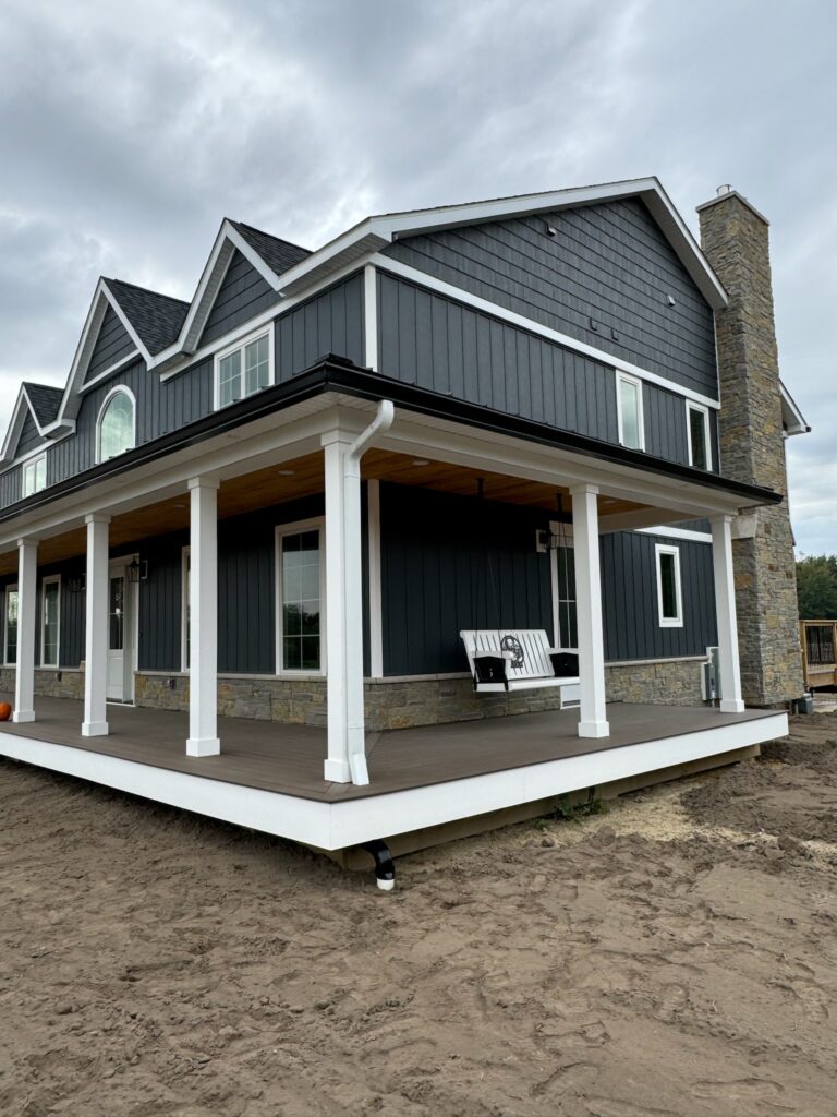 New build grey and white house with black gutters