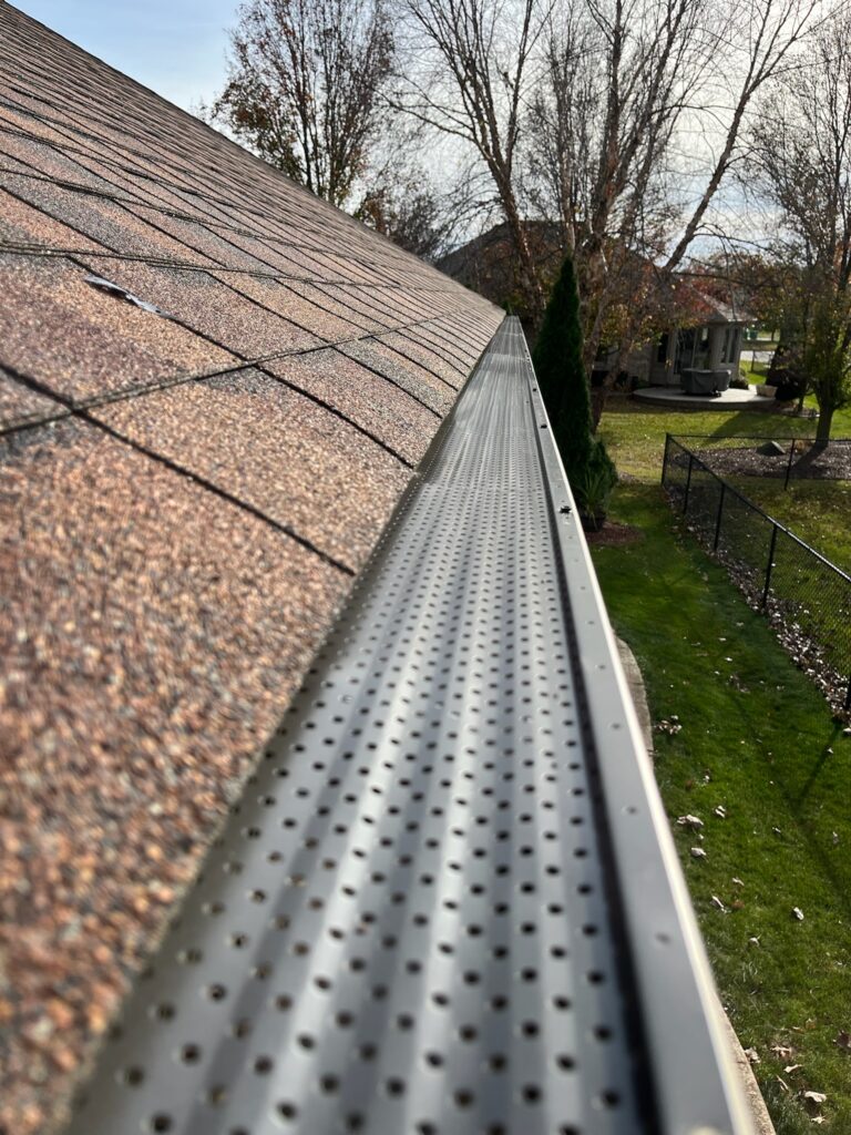 brown roof with silver gutter guards