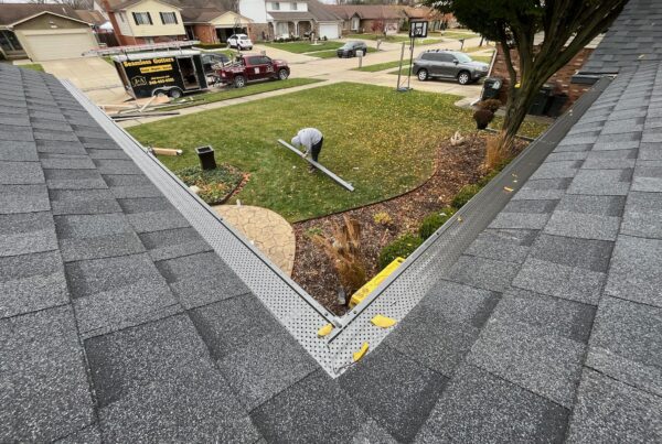 black gutter guards with men working and J&A Exterior truck in trailer in the back