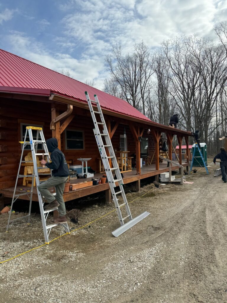 brown wood home with red metal roof