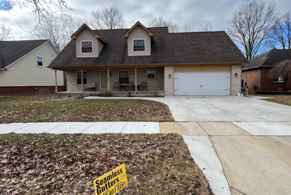 beige brick home with white garage