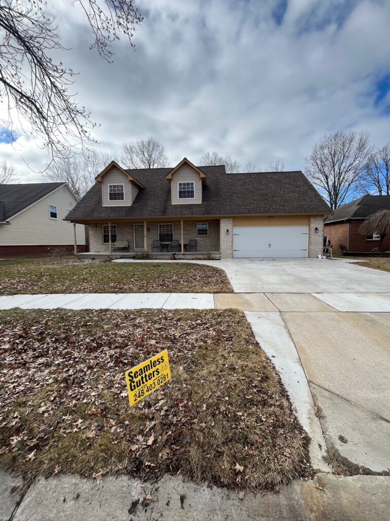 beige brick home with white garage