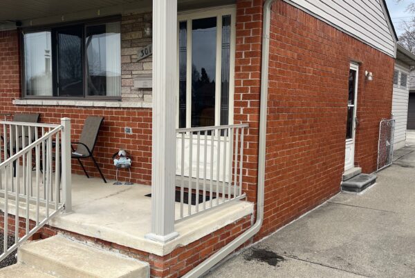 red brick home with fenced in porch