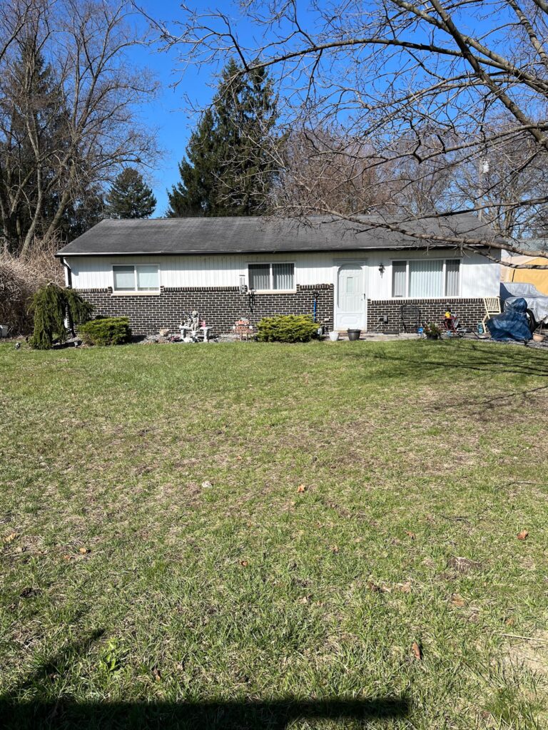 black brick and white sided home