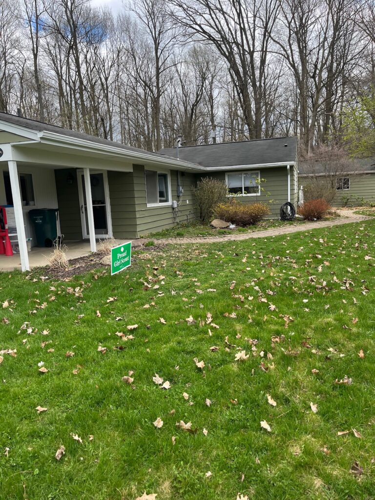 green sided one story home with white gutters