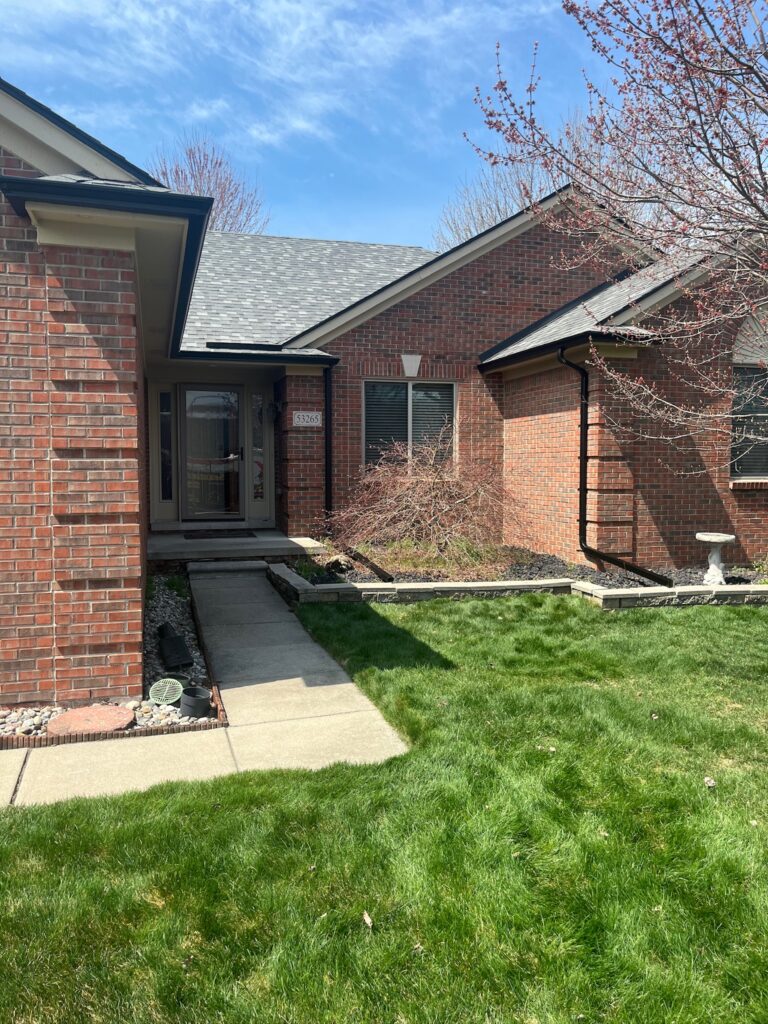 red brick home with black gutters
