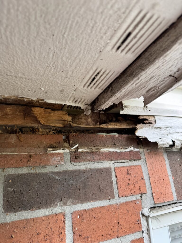 Rotted wood on red brick home