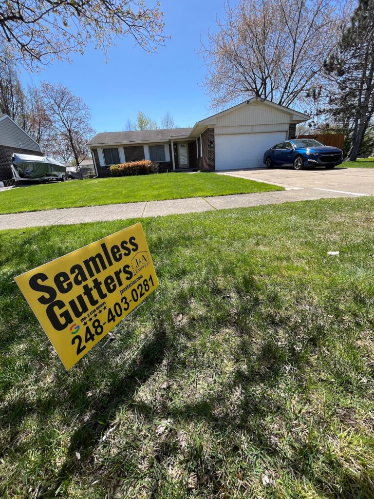 brown brick home with seamless gutter yard sign