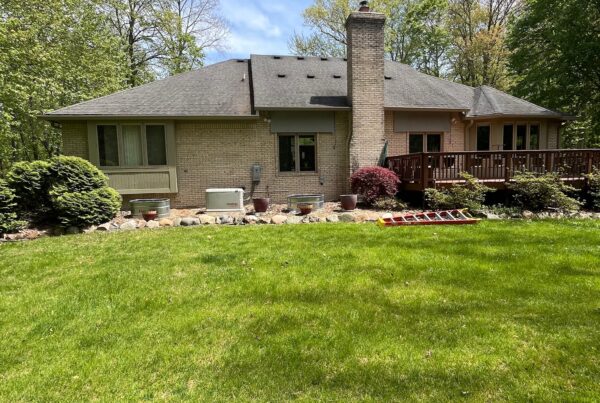 brown brick home with deck