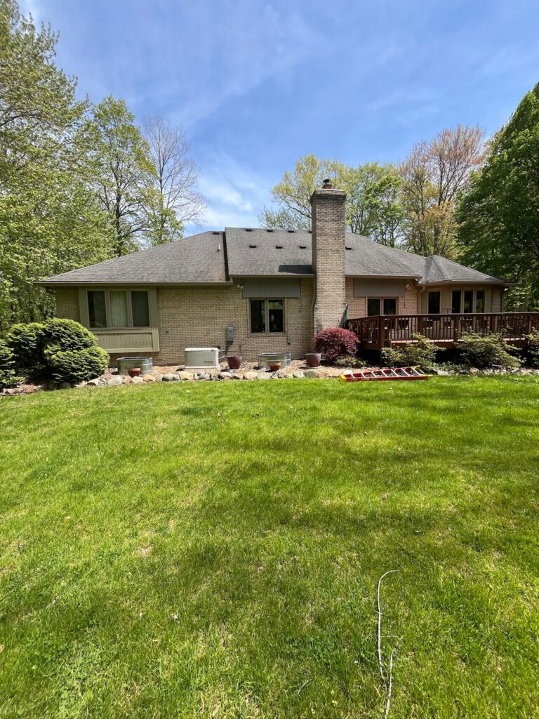 brown brick home with deck