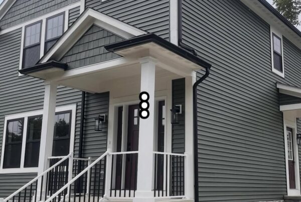 gray 2 story house with black gutters