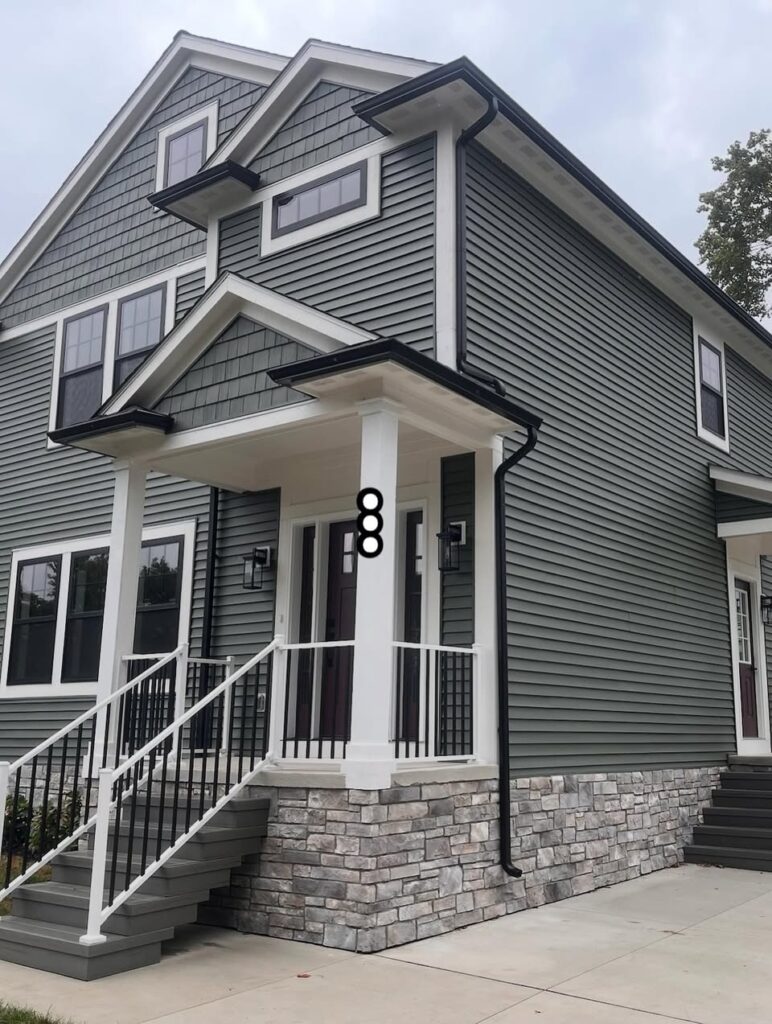 gray 2 story house with black gutters