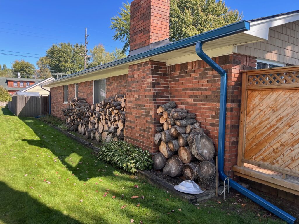 Red brick home with ocean blue gutters